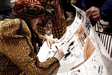 Margo Feiden signs The Hirschfeld Spectacular poster at Henri Bendel in NY